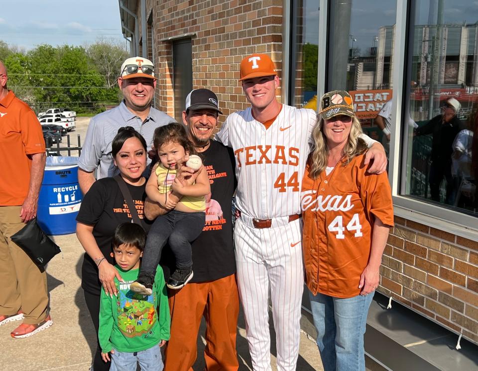 The families of Texas outfielder Max Belyeu and Fernando Martinez, center, pose for a picture at UFCU Disch-Falk Field. Martinez caught the first home run of Belyeu's college career.