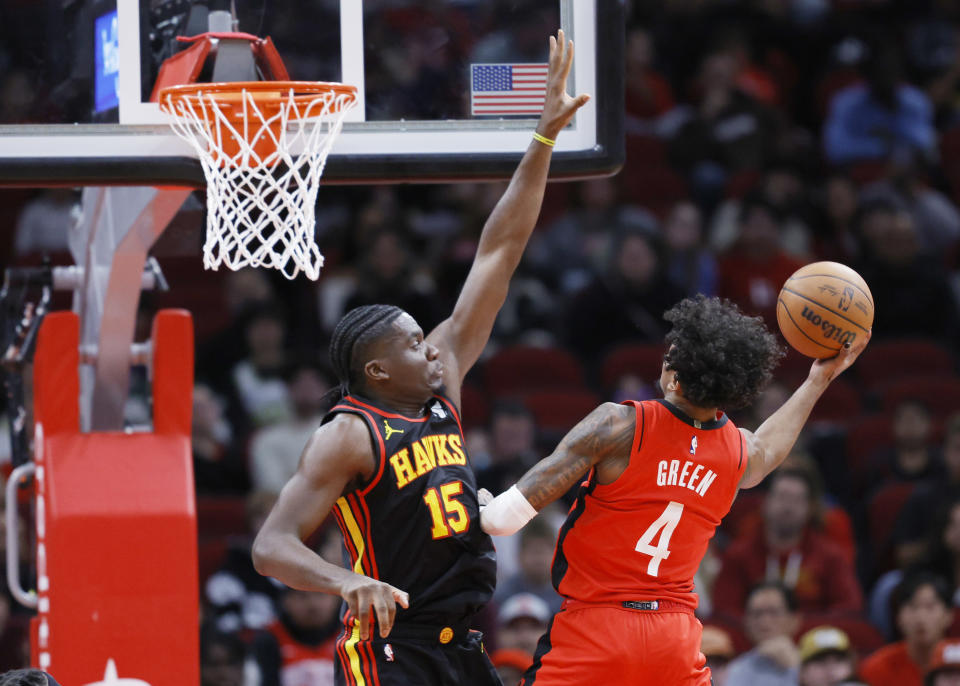 HOUSTON, TEXAS - DECEMBER 20: Jalen Green #4 of the Houston Rockets drives to the net ahead of Clint Capela #15 of the Atlanta Hawks during the first half at Toyota Center on December 20, 2023 in Houston, Texas. User expressly acknowledges and agrees that, by downloading and or using this photograph, User is consenting to the terms and conditions of the Getty Images License Agreement.   (Photo by Carmen Mandato/Getty Images)