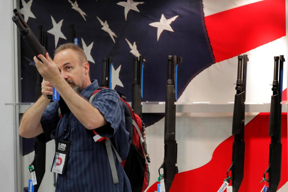 A gun enthusiast looks at a shotgun during the annual National Rifle Association (NRA) convention in Dallas, Texas, U.S., May 5, 2018: REUTERS