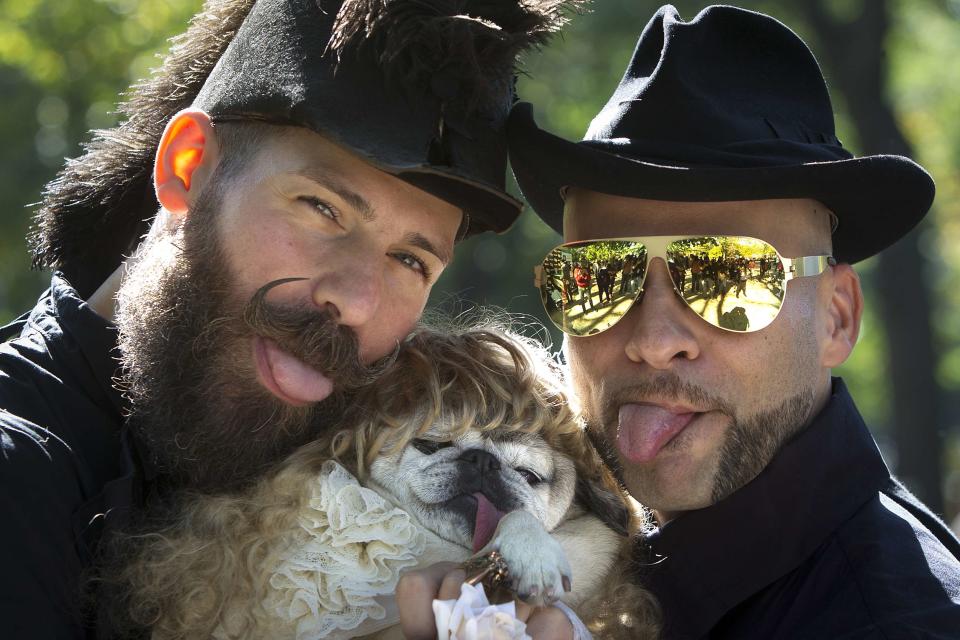 Men pose for a photo with their dog during the 24th Annual Tompkins Square Halloween Dog Parade in New York