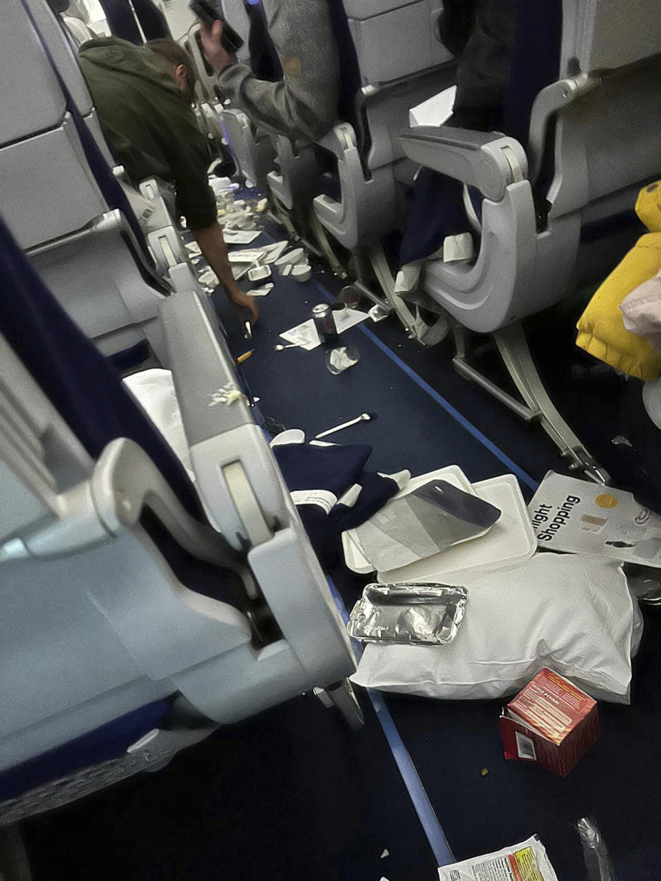 Food trays and other stuff are scattered inside the cabin as Lufthansa Flight 469 from Austin, Texas, headed to Frankfurt, Germany, that experienced “significant turbulence” and was diverted to Washington Dulles International Airport, Virginia, where it landed safely Wednesday, March 1, 2023. Crews responded to the flight and took seven people to hospitals with injuries that were believed to be minor. (Ecaterina Fadhel/via AP Photo)