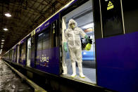 A worker disinfects subway trains against coronavirus in Tehran, Iran, in the early morning of Wednesday, Feb. 26, 2020. Iran's government said Tuesday that more than a dozen people had died nationwide from the new coronavirus, rejecting claims of a much higher death toll of 50 by a lawmaker from the city of Qom that has been at the epicenter of the virus in the country. (AP Photo/Ebrahim Noroozi)