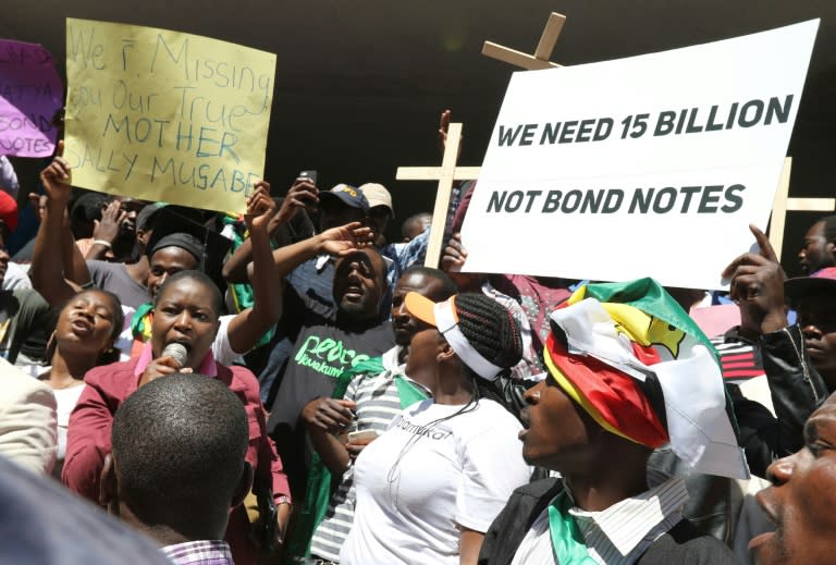 Demonstrators hold crosses and banners during a protest against the introduction of new bond notes and youth unemployement in Harare, Zimbabwe on August, 3, 2016