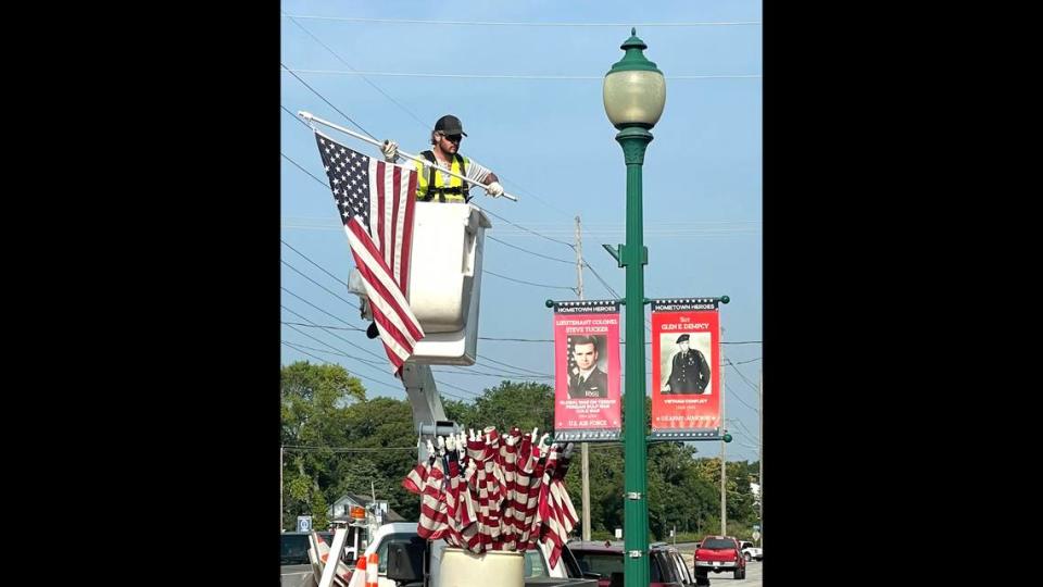Chris Carrell of the O’Fallon Public Works Department braves early morning heat and humidity to put up (and later take down) over 70 American flags to adorn the streets of O’Fallon in preparation for the annual Independence Day celebration. Provided