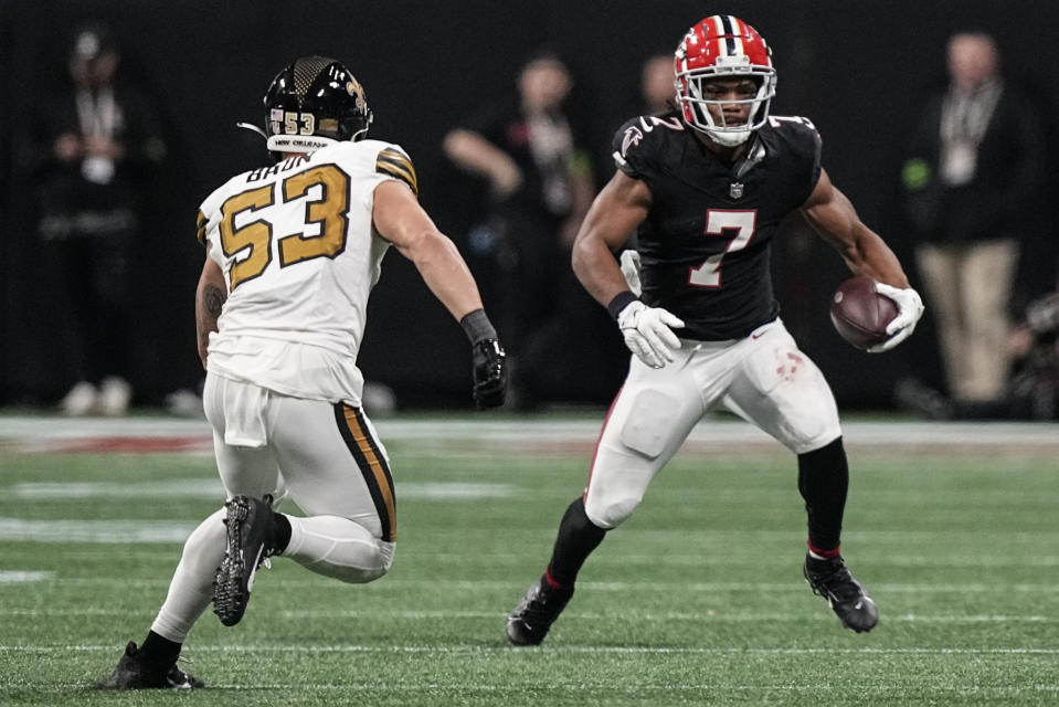 Atlanta Falcons running back Bijan Robinson (7) runs against New Orleans Saints linebacker Zack Baun (53) during the second half of an NFL football game, Sunday, Nov. 26, 2023, in Atlanta. (AP Photo/Brynn Anderson)