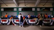 Voters pick up their ballots at Fenway Park on the first day of early voting in Boston