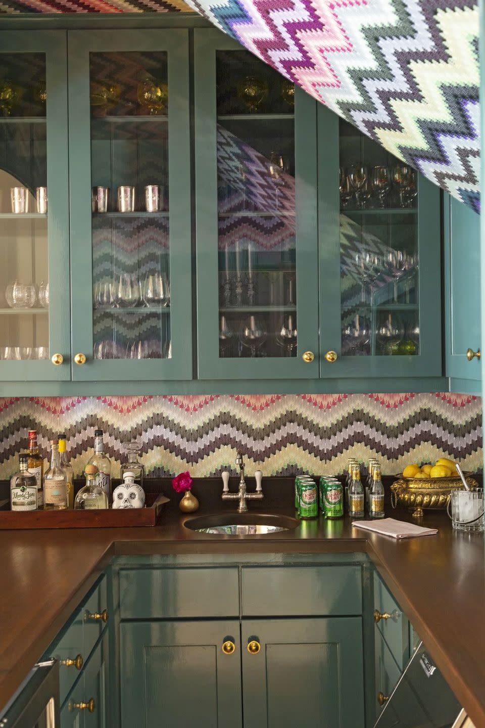 a kitchen with a sink and green cabinets