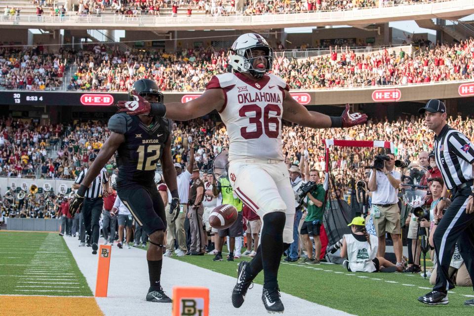 Oklahoma fullback Dimitri Flowers (36) celebrates after scoring a touchdown against Baylor during the first quarter at McLane Stadium.