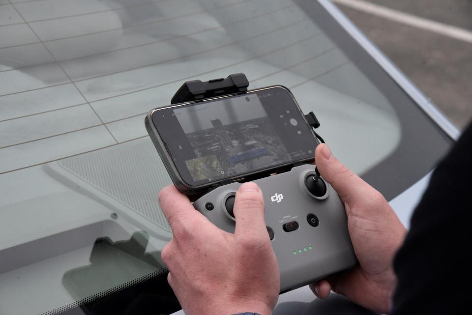 Patrick Bush, owner of Patman Droneography, flies a drone in downtown Battle Creek, Michigan on Wednesday, May 11, 2022.