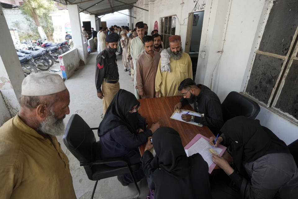 Immigrants, mostly Afghans, go through data verification process at a counter of Pakistan's National Database and Registration Authority, in Karachi, Pakistan, Tuesday, Nov. 7, 2023. Pakistan government launched a crackdown on migrants living in the country illegally as a part of the new measure which mainly target all undocumented or unregistered foreigners. (AP Photo/Fareed Khan)