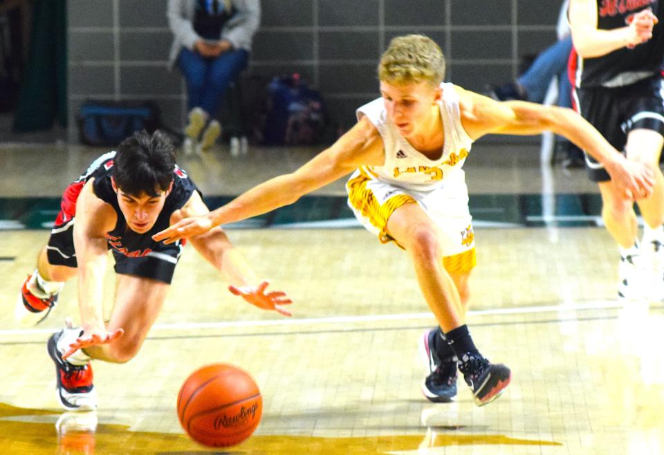 Hiland's Conner Beachy dives for the ball after he poked it away from Federal Hocking's Tariq Cottrill.