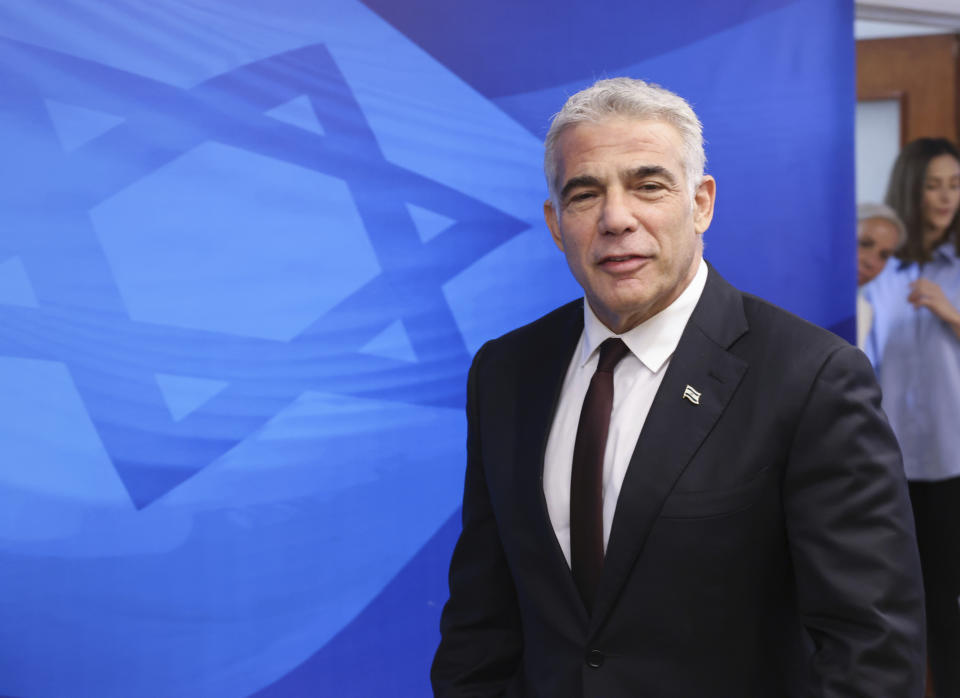 Israeli Alternate Prime Minister and Foreign Minister Yair Lapid arrives for the first weekly cabinet meeting of the new government in Jerusalem, Sunday, June 20, 2021. Prime Minister Naftali Bennett opened his first Cabinet meeting on Sunday since swearing in his new coalition government with a condemnation of the newly elected Iranian president, whom he called “the hangman of Tehran.” (Emmanuel Dunand/Pool Photo via AP)