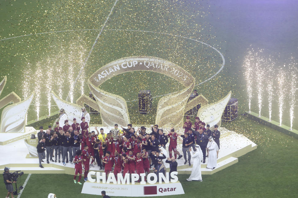 Team Qatar poses with the winning trophy at the end of the Asian Cup final soccer match between Qatar and Jordan at the Lusail Stadium in Lusail, Qatar, Saturday, Feb. 10, 2024. (AP Photo/Hussein Sayed)