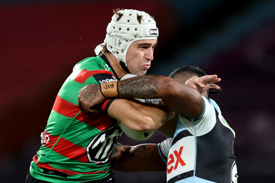 SYDNEY, AUSTRALIA - APRIL 13: Jye Gray of the Rabbitohs is tackled by the Sharks defence during the round six NRL match between South Sydney Rabbitohs and Cronulla Sharks at Accor Stadium, on April 13, 2024, in Sydney, Australia. (Photo by Brendon Thorne/Getty Images)