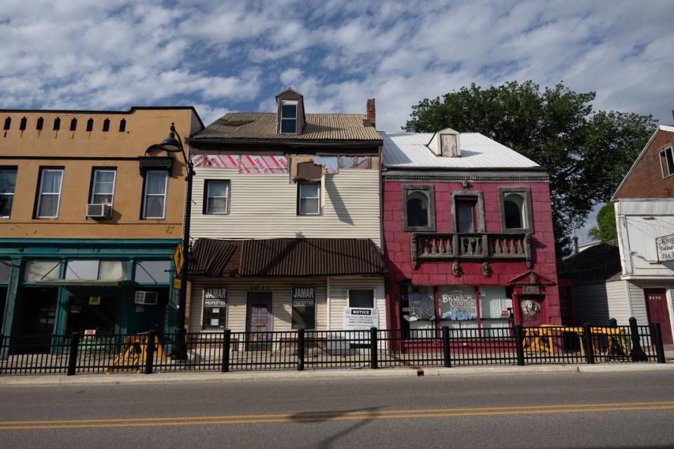 St. Clair County, on request from the city of Belleville, plans to demolish a storefront at 1013 W. Main St., center. The 2 1/2-story brick building is covered with tan vinyl siding that is peeling off.