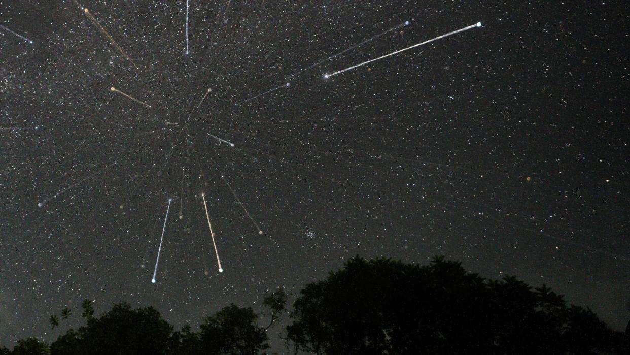  Streaks of light can be seen among the stars of the night sky. 