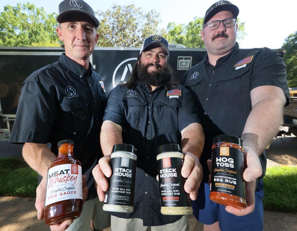 M/W Smokers team members, Brian Wynn (center), from left, Brian Cox and Brandon Massey have launched the Meat Whiskey line of BBQ sauce and dry rubs after honing their skills competing at the Memphis in May World Championship Barbecue Cooking Contest.