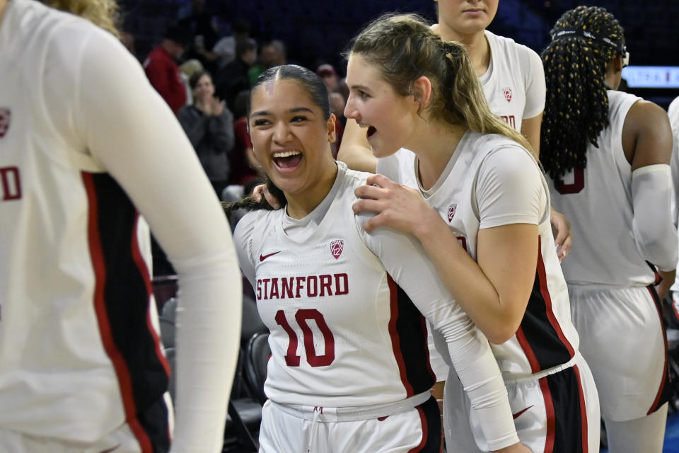 Stanford guard Talana Lepolo (10) and guard Hannah Jump celebrate the team's victory over Oregon in an NCAA college basketball game in the quarterfinals of the Pac-12 women's tournament Thursday, March 2, 2023, in Las Vegas. (AP Photo/David Becker)