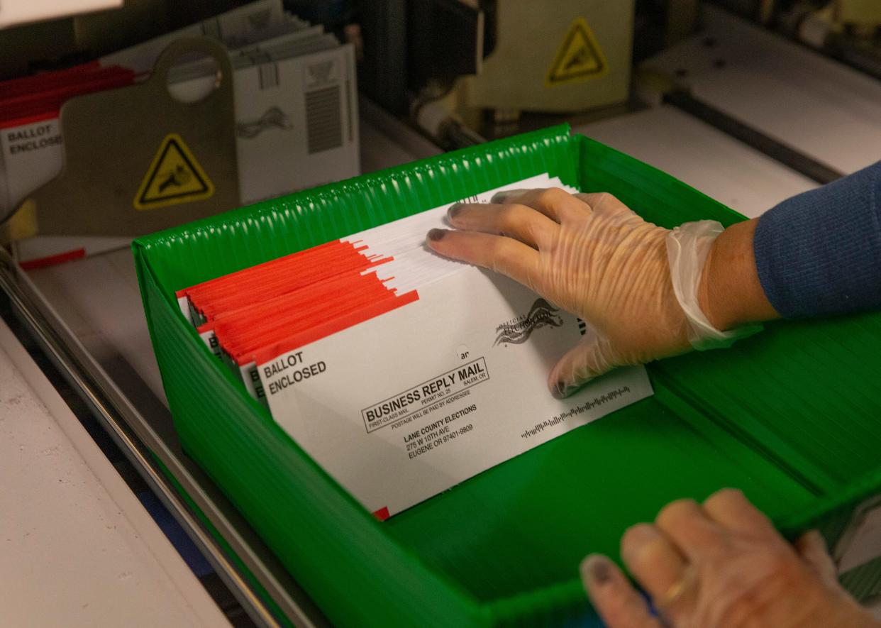 An election worker prepares ballots for counting at the Lane County Elections office in Eugene on Nov. 8, 2022.