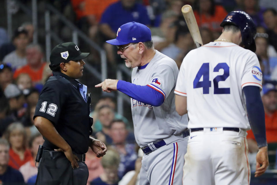 Texas Rangers manager Bruce Bochy, center, argues with home plate umpire Erich Bacchus (12) after Bacchus ejected Bochy, while Houston Astros batter Kyle Tucker waits to the side during the seventh inning of a baseball game Saturday, April 15, 2023, in Houston. (AP Photo/Michael Wyke)