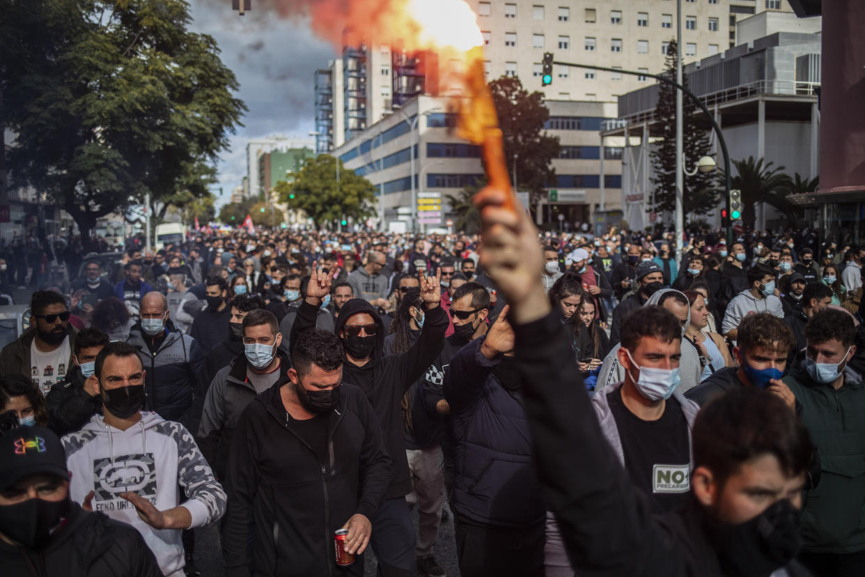 Protesters march during a strike organized by metal workers in Cadiz, southern Spain, Tuesday, Nov. 23, 2021. (AP Photo/Javier Fergo)