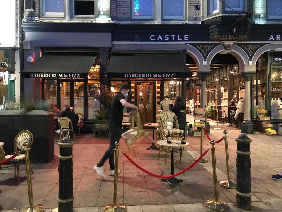 Staff put away chairs in Cardiff city centreEmily Clark