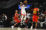 Houston Rockets forward Danuel House Jr.(4) goes high to catch a pass as Atlanta Hawks guard Trae Young (11) defends during the first half of an NBA basketball game Wednesday, Jan. 8, 2020, in Atlanta. (AP Photo/John Amis)