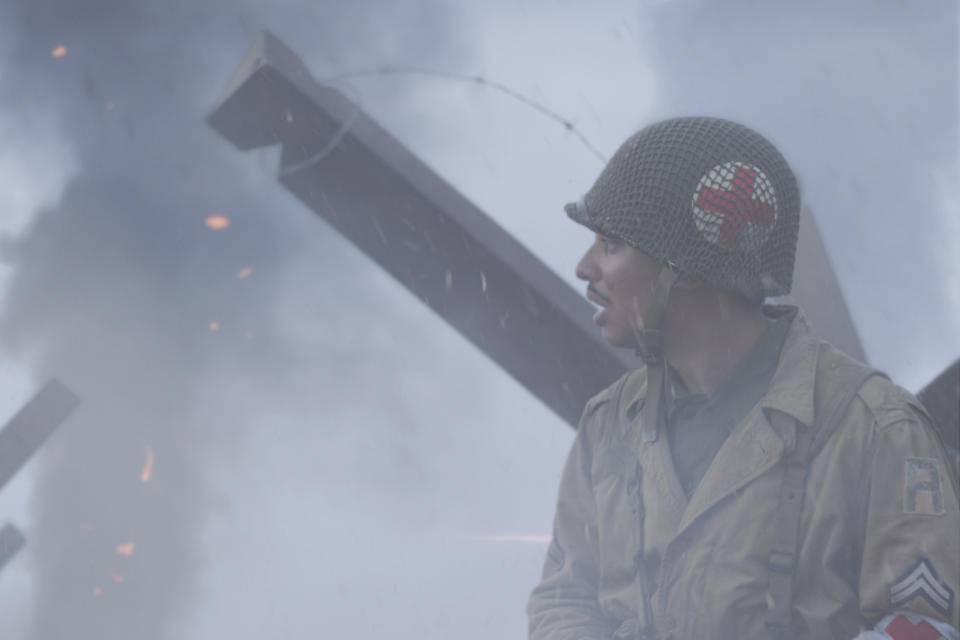 This image released by National Geographic shows actor Francesco Di Rauso, portraying combat medic Waverly Woodson Jr., who served with the 320th Barrage Balloon Battalion on D-Day, in a scene from "Erased: WW2's Heroes of Color." (National Geographic via AP)