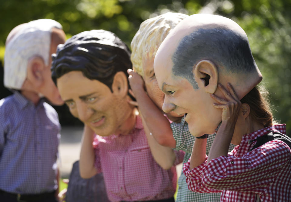 Activists from Oxfam put on giant heads depicting G7 leaders during a demonstration in Munich, Germany, Saturday, June 25, 2022. The G7 Summit will take place at Castle Elmau near Garmisch-Partenkirchen from June 26 through June 28, 2022. Leaders depicted from left, U.S. President Joe Biden, Canada's Prime Minister Justin Trudeau, British Prime Minister Boris Johnson and German Chancellor Olaf Scholz. (AP Photo/Matthias Schrader)