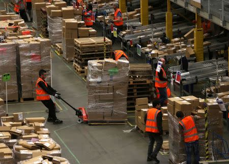 Workers collect customer orders during Black Friday deals week at an Amazon fulfilment centre in Hemel Hempstead, Britain November 25, 2015. REUTERS/Neil Hall