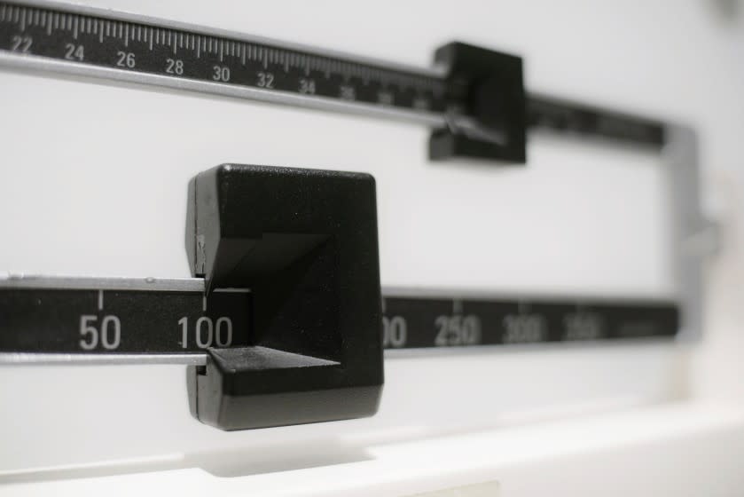 This Tuesday, April 3, 2018 file photo shows a closeup of a beam scale in New York. A study by the U.S. Centers for Disease Control and Prevention released on Thursday, Sept. 16, 2021, ties the COVID-19 pandemic to an "alarming" increase in obesity in U.S. children and teenagers. (AP Photo/Patrick Sison, File)