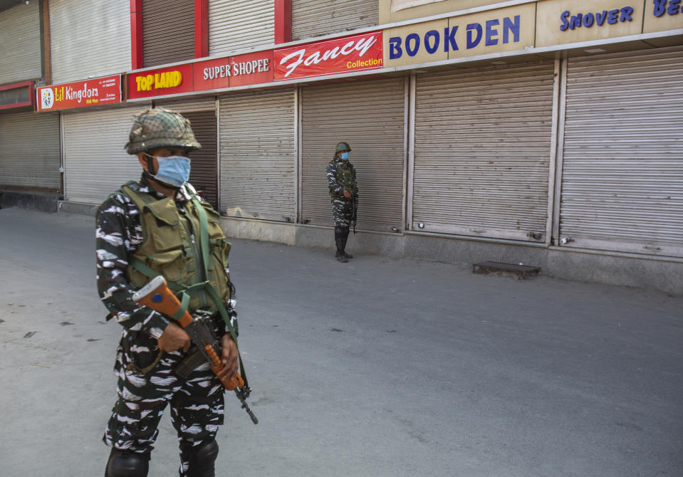 Indian paramilitary soldiers guard at a closed market in Srinagar, Indian controlled Kashmir, Sunday, Sept. 5, 2021. Authorities Sunday eased some restrictions that had been imposed after the death of top resistance leader Syed Ali Geelani. However, most shops and businesses stayed closed as government forces patrolled roads and streets in the city. (AP Photo/Mukhtar Khan)