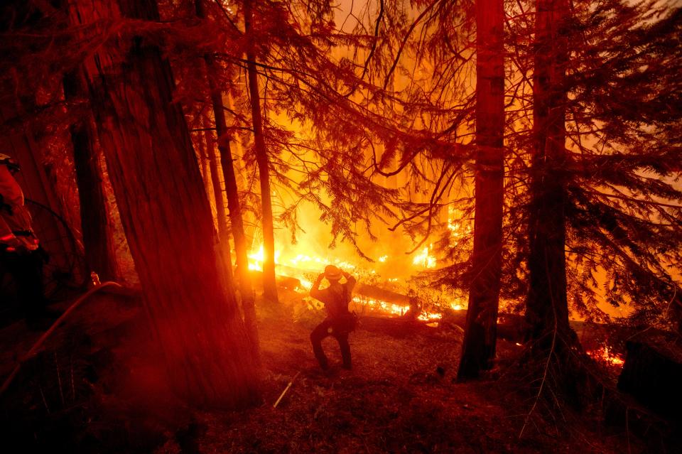 A firefighter battles the Creek Fire in the Shaver Lake community of Fresno County, Calif., on Monday, Sept. 7, 2020.