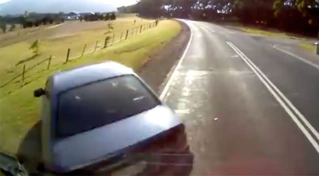 The truckie slams his brakes but still clips the back of the sedan as it turned. Source: Dash Cam Owners Australia/ Facebook