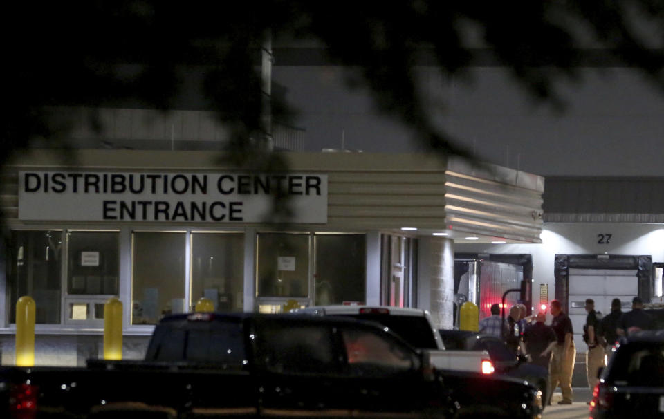 Authorities investigate the scene after a deadly shooting at Ben E. Keith distribution center Monday, Aug. 20, 2018, in Missouri City, Texas. Missouri City Police Chief Mike Berezin says the shooting happened during the overnight shift, when fewer workers are on duty. (Yi-Chin Lee/Houston Chronicle via AP)