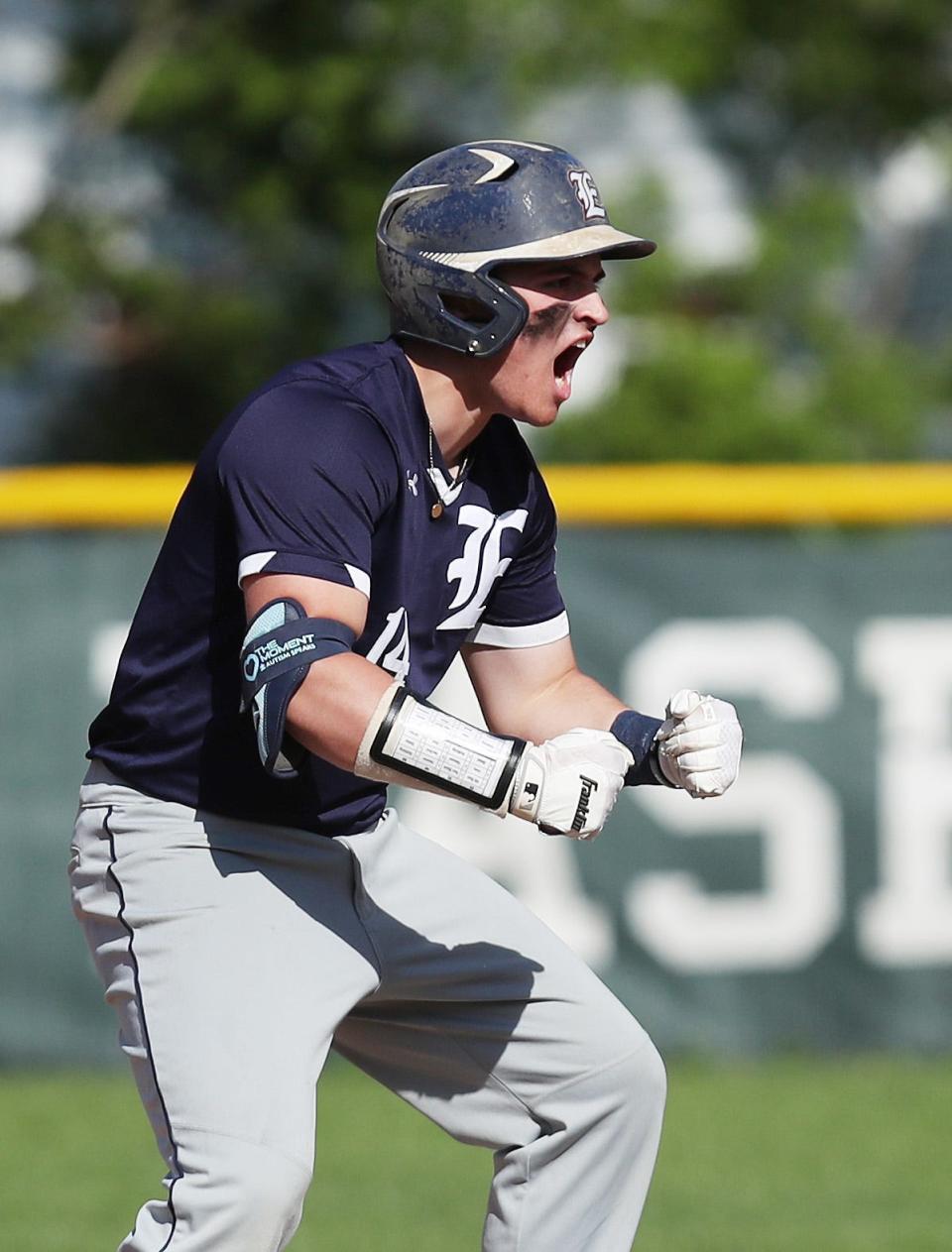 Eastchester's AJ DiBenedetto (14) pumps up his teammates after hitting a double against Rye during baseball playoff action at Disbrow Park in Rye May 25, 2022. Eastchester won the game 3-2 in extra innings.