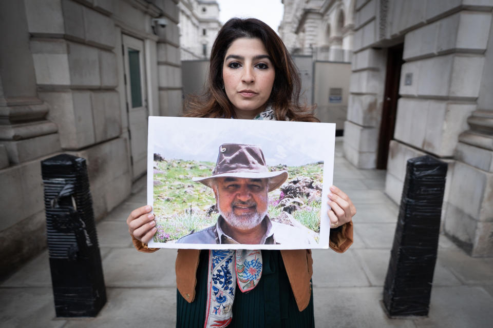 Roxanne Tahbaz holds a picture of her father Morad Tahbaz during a protest (Stefan Rousseau / PA Images via Getty Images file)