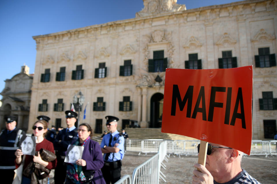 People protest outside the office of the Prime Minister at Castille, in Valletta, Malta, Tuesday, Dec. 3, 2019, as a delegation od European Union lawmakers is visiting the country after an investigation into the murder of leading investigative journalist Daphne Caruana Galizia implicated Prime Minister Joseph Muscat’s chief of staff. (AP Photo/Rene Rossignaud)