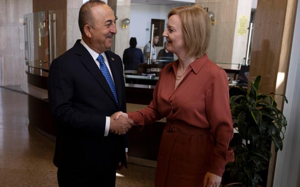 Foreign Secretary Elizabeth Truss greets Turkish Foreign Minister Mevlut Cavusoglu before their talks in Ankara, Turkey today - Umit Bektas/Reuters