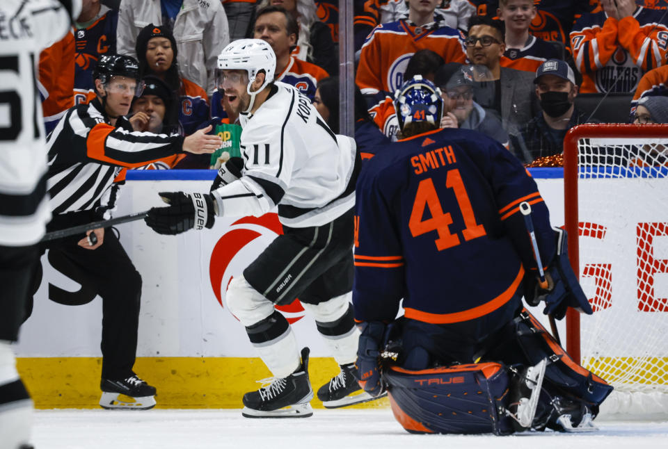 Los Angeles Kings center Anze Kopitar, left, celebrates his team's winning goal as Edmonton Oilers goalie Mike Smith looks on during overtime in Game 5 of an NHL hockey Stanley Cup first-round playoff series, Tuesday, May 10, 2022 in Edmonton, Alberta. (Jeff McIntosh/The Canadian Press via AP)