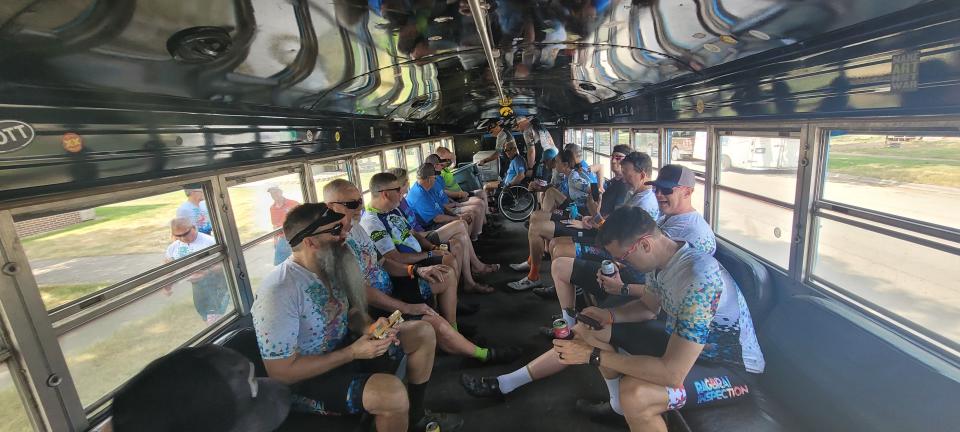 Members of the RAGBRAI route inspection team sit on a bus in Lake View on Monday.