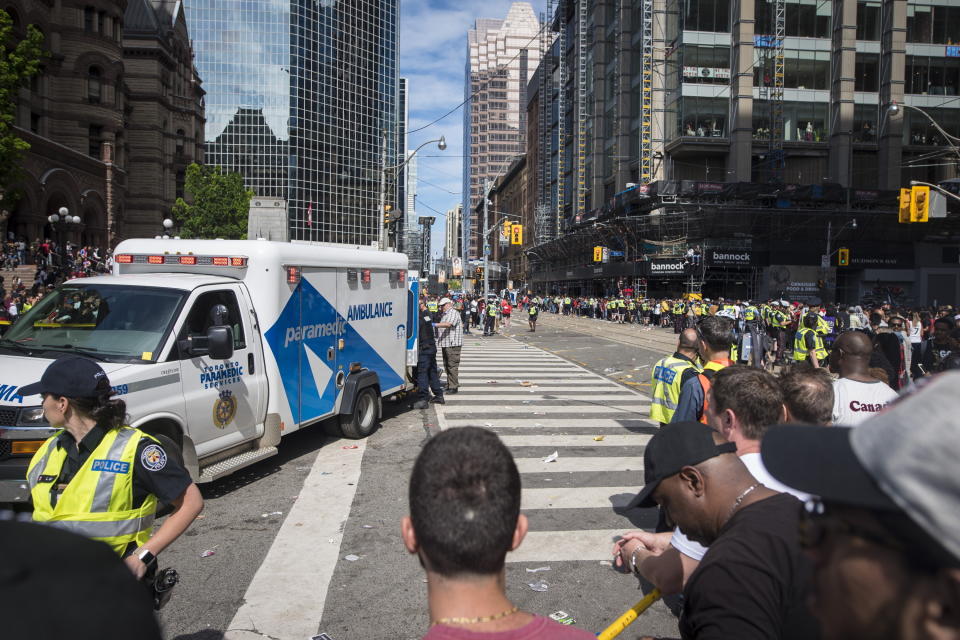 An ambulance arrives to the scene after shots were fired during the Toronto Raptors NBA basketball championship victory celebration near Nathan Phillips Square in Toronto, Monday, June 17, 2019. (Tijana Martin/The Canadian Press via AP)