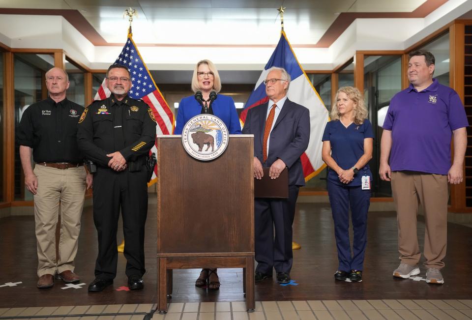 Texas Land Commissioner Dawn Buckingham speaks at a news conference Tuesday about redeveloping the William P. Hobby Jr. State Office Building into what she hopes will be "the single most transformational workforce housing project in this country." Listening are, from left, Bob Nicks, of the Austin Firefighters Association president, Williamson County Precinct 2 Constable Jeff Anderson, Mayor Kirk Watson, Registered Nurse Nancy Sisk and teacher Brent Walker.