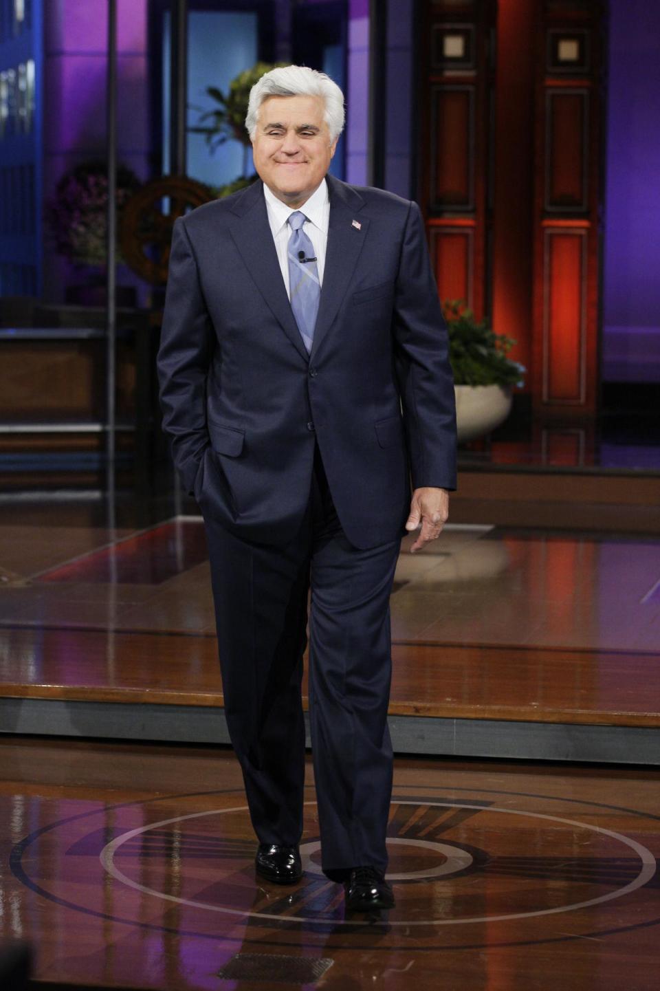 This April 3, 2013 publicity photo released by NBC shows host Jay Leno on the set of "The Tonight Show with Jay Leno," Season 21, Episode 4437, in Burbank, Calif. The role of female talk-show hosts in late-night TV network history, all 50-plus years of it, can be summed up in two words: Joan Rivers. It takes just another two _ Arsenio Hall _ to do the same for minorities. There's no indication that's going to change in the latest round of musical chairs involving "Tonight" and "Late Night." (AP Photo/NBC, Paul Drinkwater)