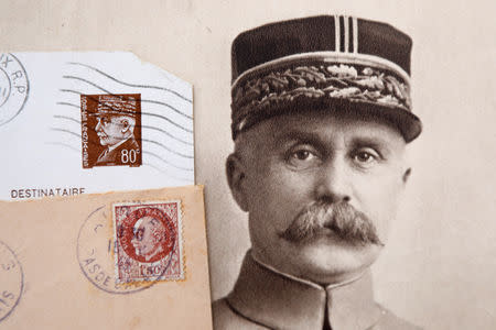 Stamps and a portrait of French General Philippe Petain, published in the French newspaper ''L'Illustration" on August 4, 1917 (R), are seen in this picture illustration taken November 8, 2018. REUTERS/Charles Platiau/Illustration