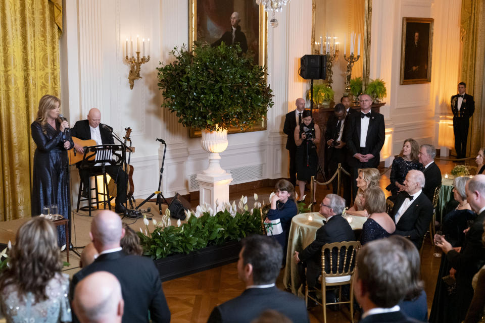 President Joe Biden and first lady Jill Biden listen to country singer Trisha Yearwood perform during a reception for members of the National Governors Association and their spouses in the East Room of the White House in Washington, Saturday, Feb. 24, 2024. (AP Photo/Stephanie Scarbrough)