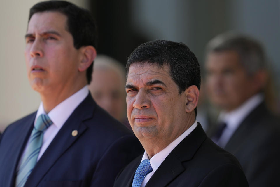 FILE - Vice President Hugo Velazquez, right, attends a departure ceremony at the airport in Luque, Paraguay, Aug. 25, 2022. The United States has sanctioned former President Horacio Cartes and Velazquez, unveiling accusations on Thursday, Jan. 26, 2023, that the two participated in widespread schemes of corruption and have ties to members of a terrorist organization. (AP Photo/Jorge Saenz, File)