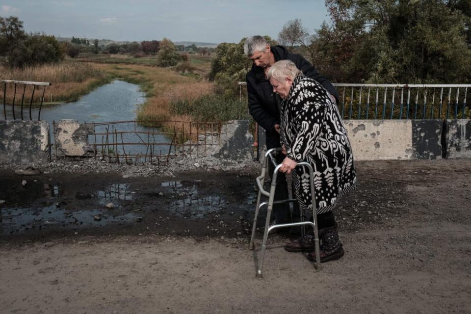 <div class="inline-image__caption"><p>Local residents evacuate and cross the bridge over the Oskil River in Kupiansk, in the recently retaken area near Kharkiv.</p></div> <div class="inline-image__credit">Yasuyoshi Chiba/AFP via Getty</div>