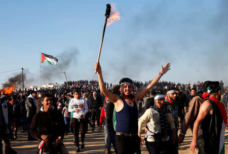 Palestinian demonstrators take part in a protest at the Israel-Gaza border fence, east of Gaza City February 22, 2019. REUTERS/Mohammed Salem