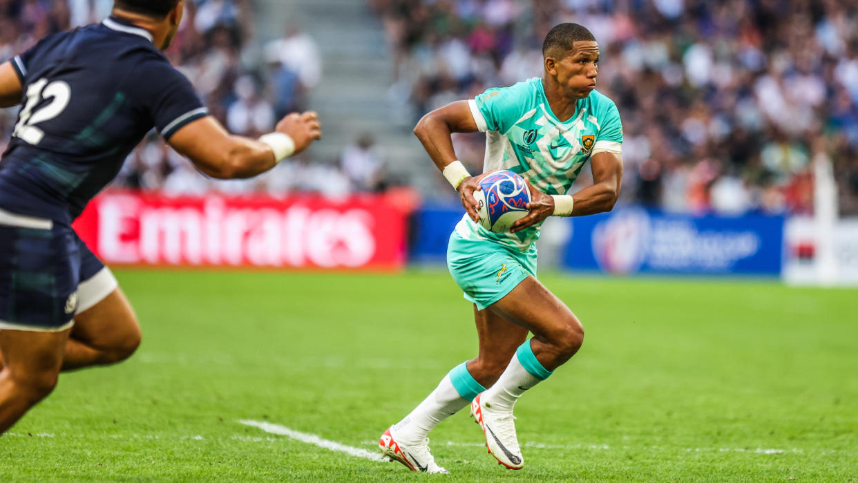  South Africa's Manie Libbok running with a ball in the team's Rugby World Cup game against Scotland. 